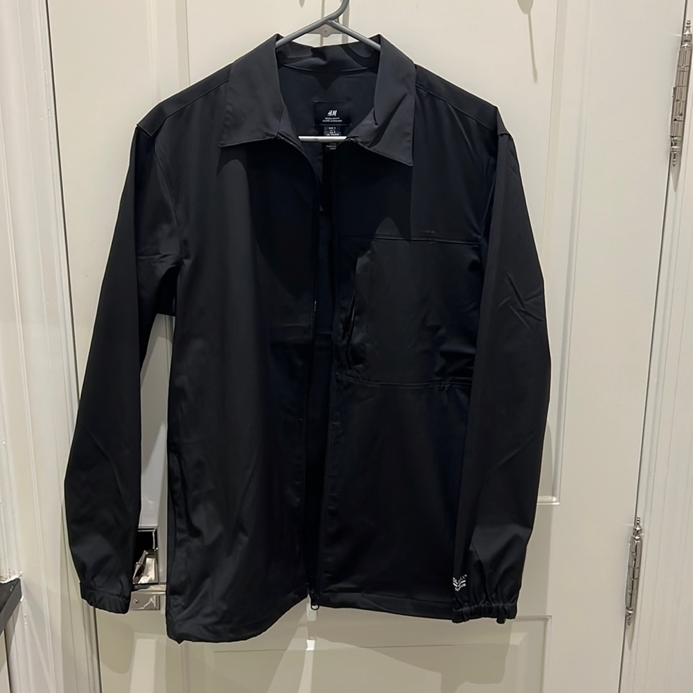 Black polyester jacket.  Never worn